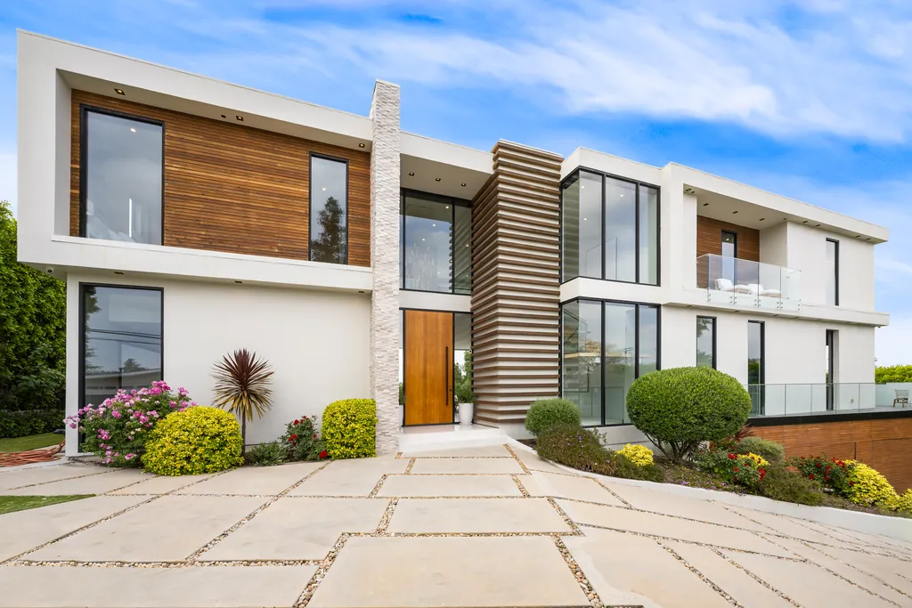 Modern house with a planted front garden and pale paving