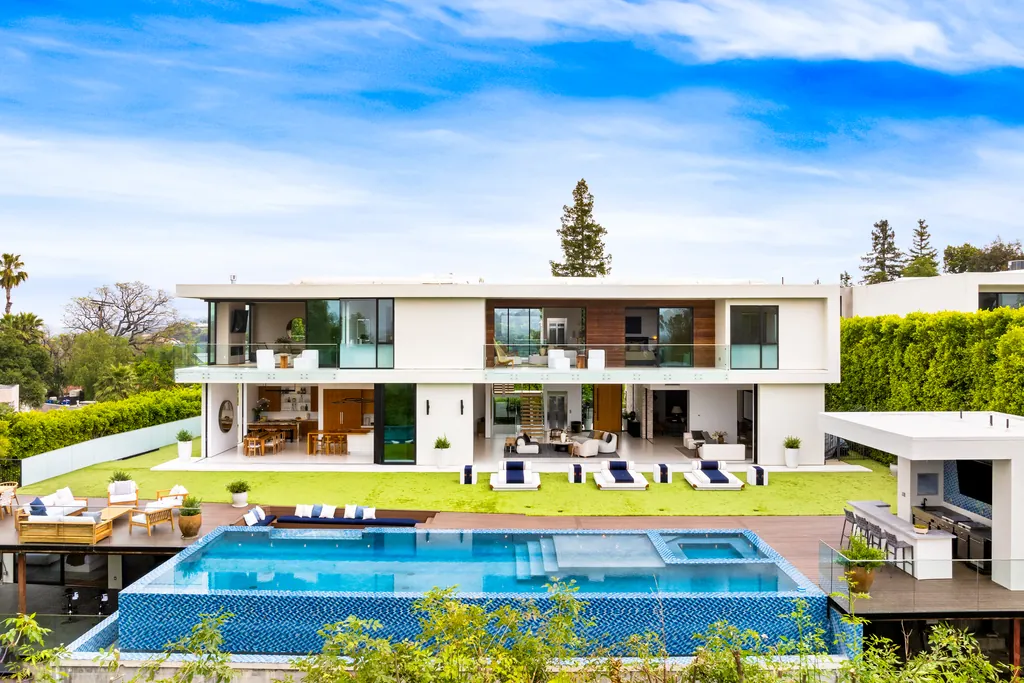 Modern villa with pool, lawn and lounge furniture