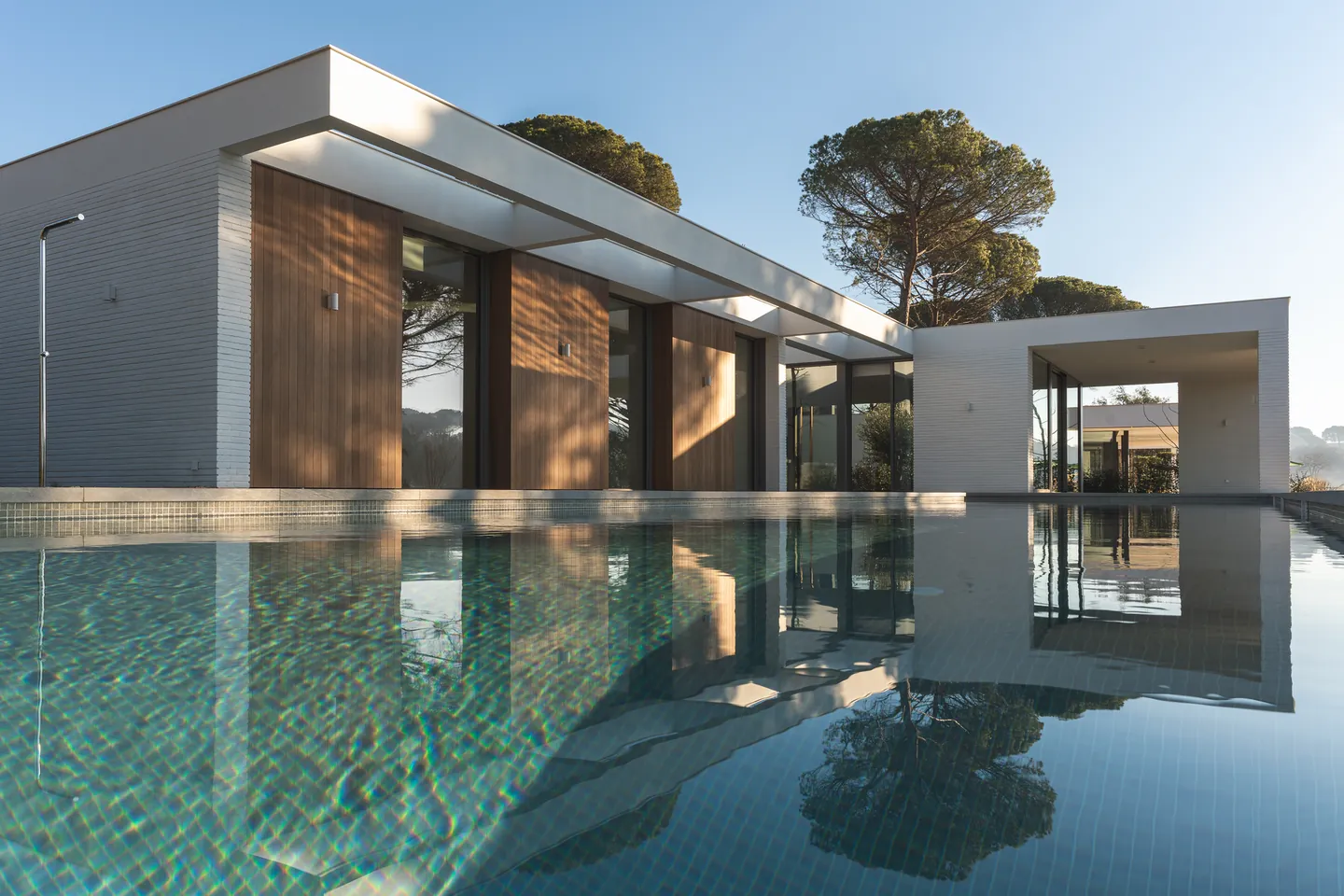 Modern villa reflected in a still pool